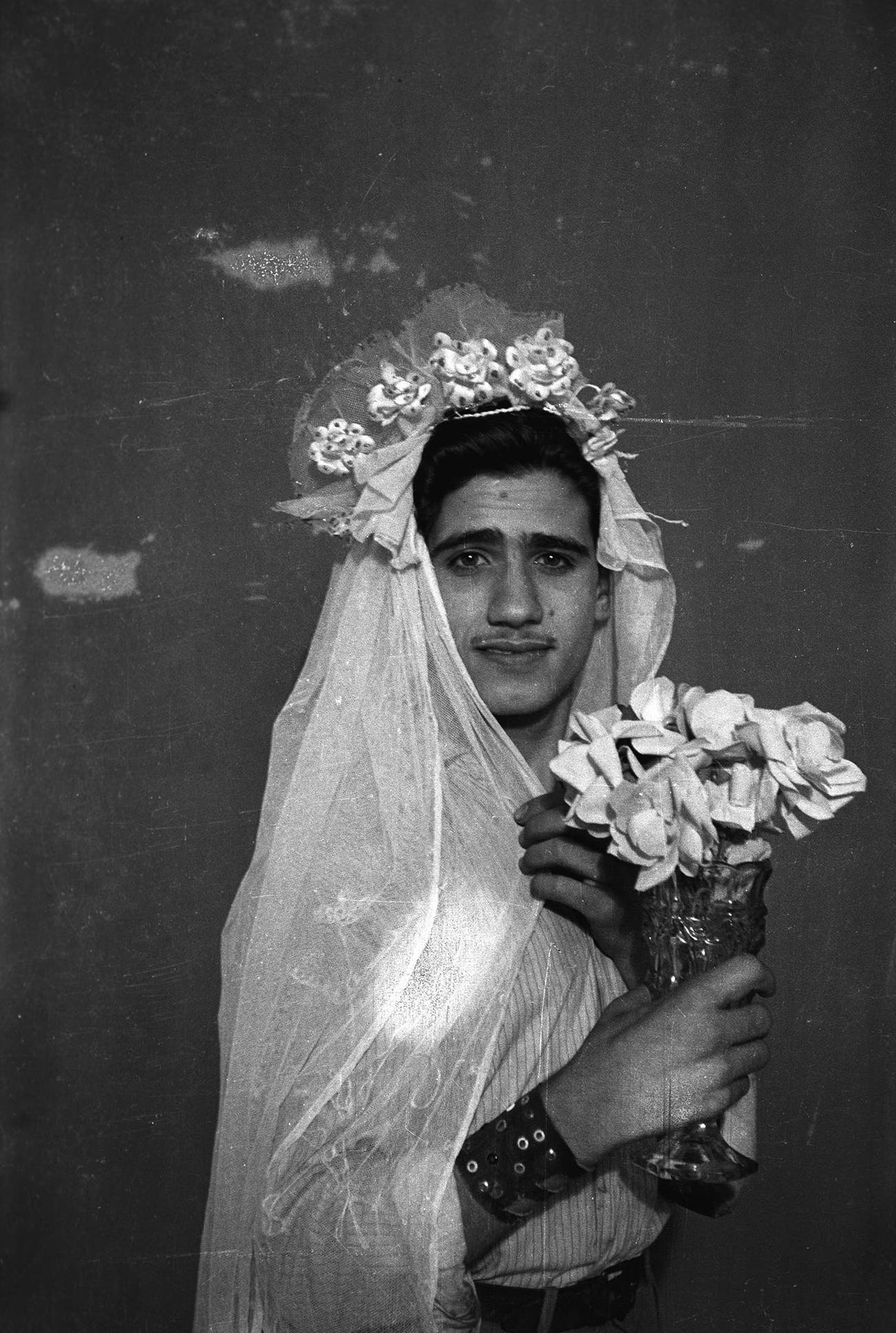 <p><strong>AKRAM ZAATARI</strong> <em>Footnotes to Studio Practices; Najm posing with wedding dress</em>, 2015</p>
