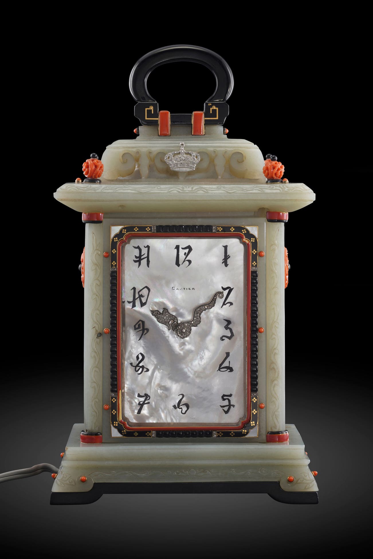 <p><strong>CARTIER</strong> <em>An exceptional, unique and museum-quality nephrite, onyx, laquer, diamond and coral-set illuminated desk clock styled as a lantern with double mother-of-pearl dials, and presentation box</em>, Circa 1925</p>
