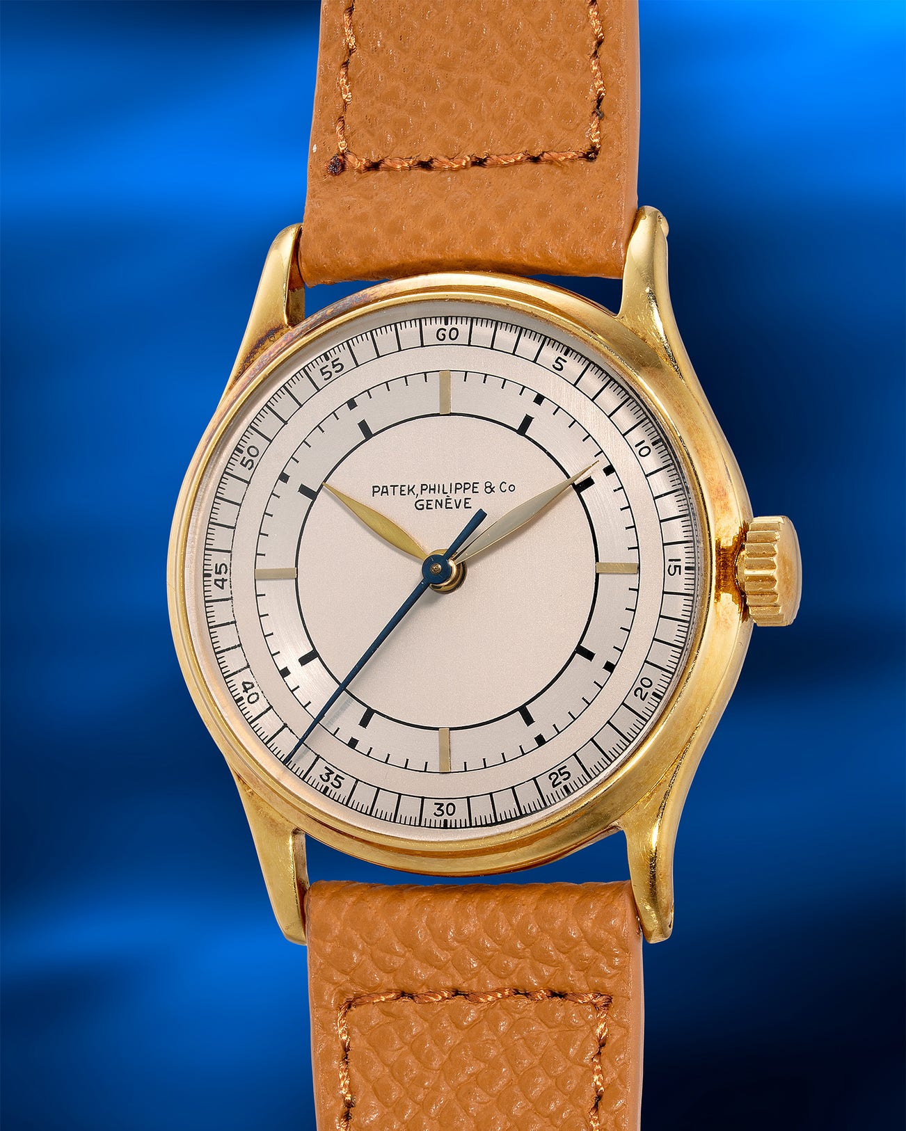 <p><strong>PATEK PHILIPPE</strong> <em>Ref. 130 in yellow gold with two-tone silvered sector dial, the only known example with center seconds</em></p>