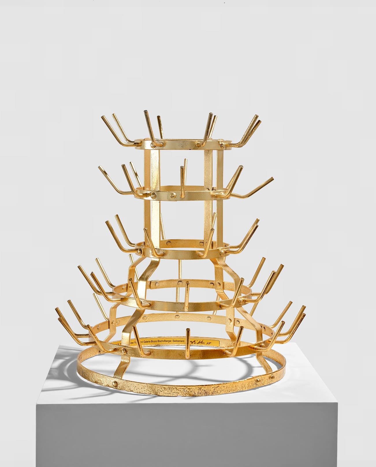 <p><strong>MIKE BIDLO</strong> <em>Gilded Bottle Rack (Not Duchamp Bottle Rack 1914),</em> $10,000–15,000</p>