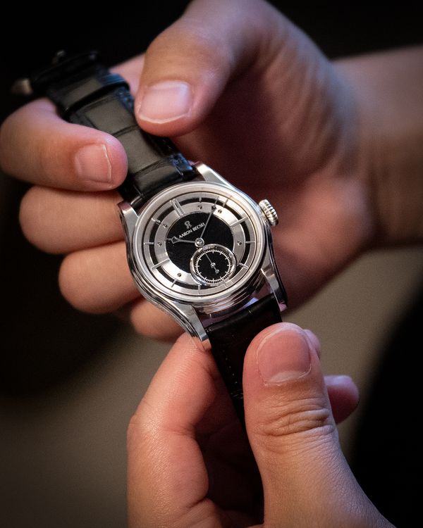A collector examines Becsei's new Pameus in platinum at the recent event at Phillips Geneva.