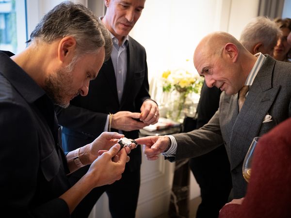 Designer Mo Coppoletta points out a detail of the buckle at the recent event Phillips Geneva.