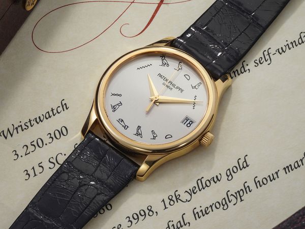 Lot 22: A 2002 Patek Philippe Ref. 3998J-013 Unique "HALMUT NAUTUN" in 18k yellow gold with hieroglyph dial, included in the Phillips Geneva Watch Auction: XXIII. Estimate: CHF80,000 - 160,000