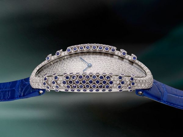 Lot 1057: A circa 2019 Libre Baignoire Allongée with pavé-set diamonds and blue sapphires, 18k white gold, included in the Phillips Hong Kong Watch Auction: XXII. Estimate: HK$300,000 -600,000.