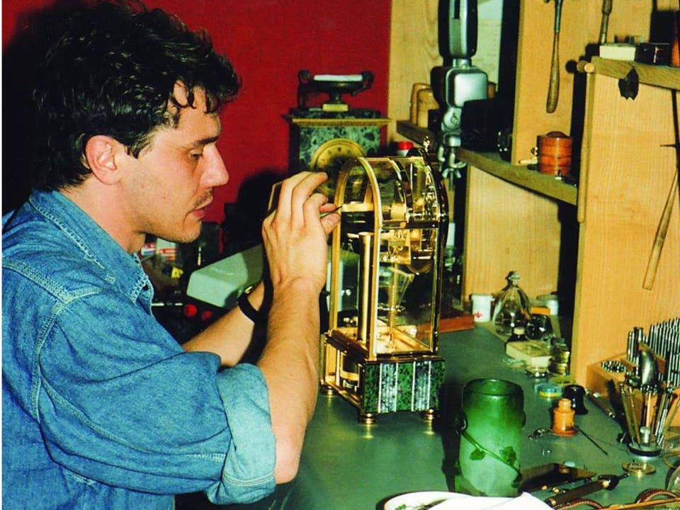 François-Paul Journe working on a remontoir-equipped Sympathique clock in his Paris workshop, between his early pocket watches and first tourbillon wristwatch.