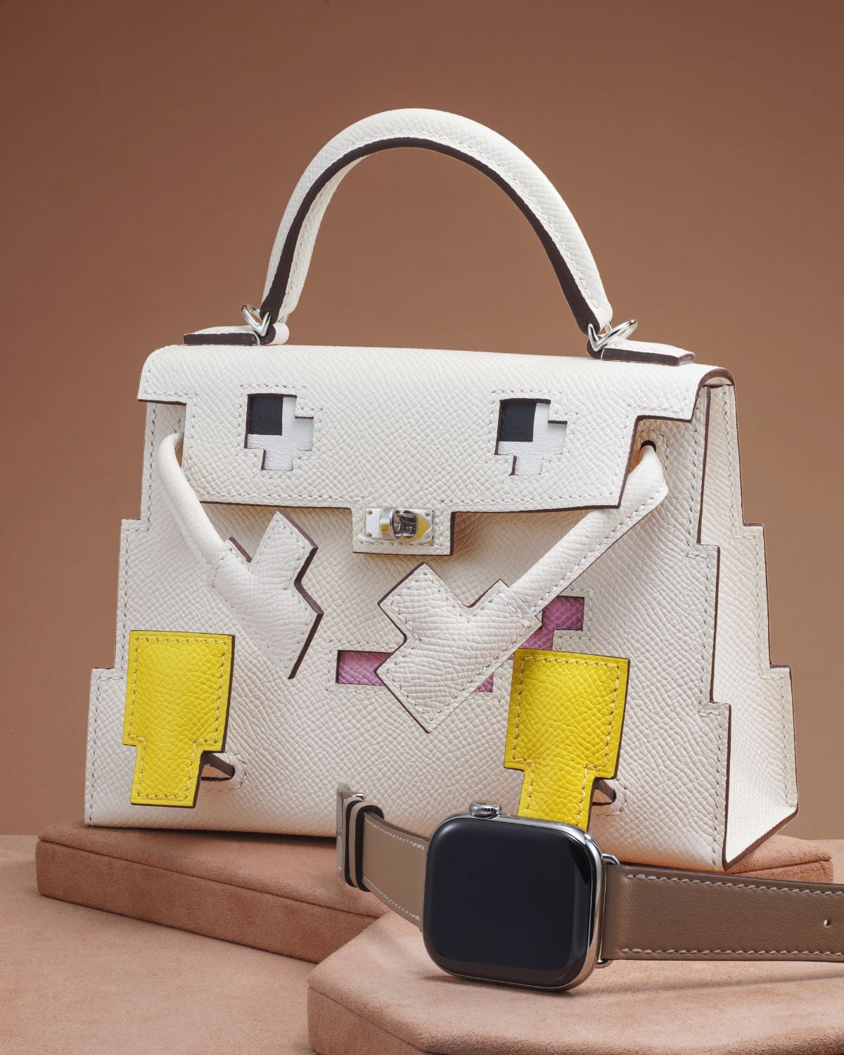 Lot 2: An Apple Watch Hermès with Hermès Kelly Doll Picto bag and accessories, included in the Phillips Geneva Sessions, Fall 2026, Online Auction. Estimate: CHF 20,000–40,000