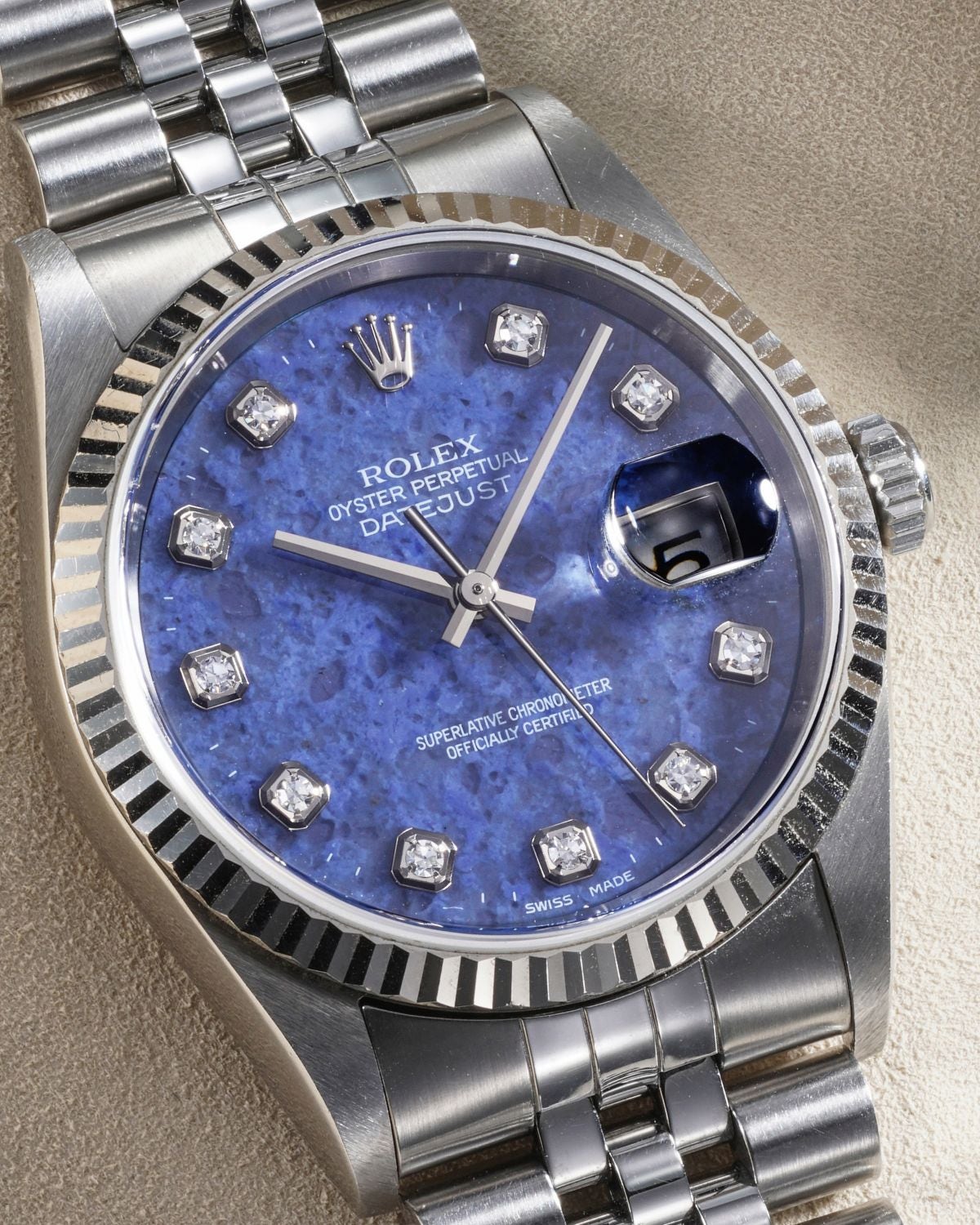 Lot 22: A 2000 Rolex Datejust Ref. 16234 in stainless steel with blue sodalite dial and diamond-set indexes, included in the Phillips Geneva Sessions, Fall 2026, Online Auction. Estimate: CHF 7,000–14,000