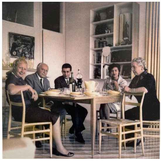 Gio Ponti and the Nemazee family gathered around the present extendable dining table in Ponti's Via Dezza apartment, circa 1960. Image: © Gio Ponti Archives / archivio storico Gio Ponti