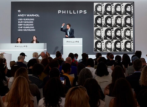 Henry Highley auctioneering Andy Warhol’s 1964 work 'Sixteen Jackies' at the Modern & Contemporary Art Evening Sale in New York on 19 May 2026.