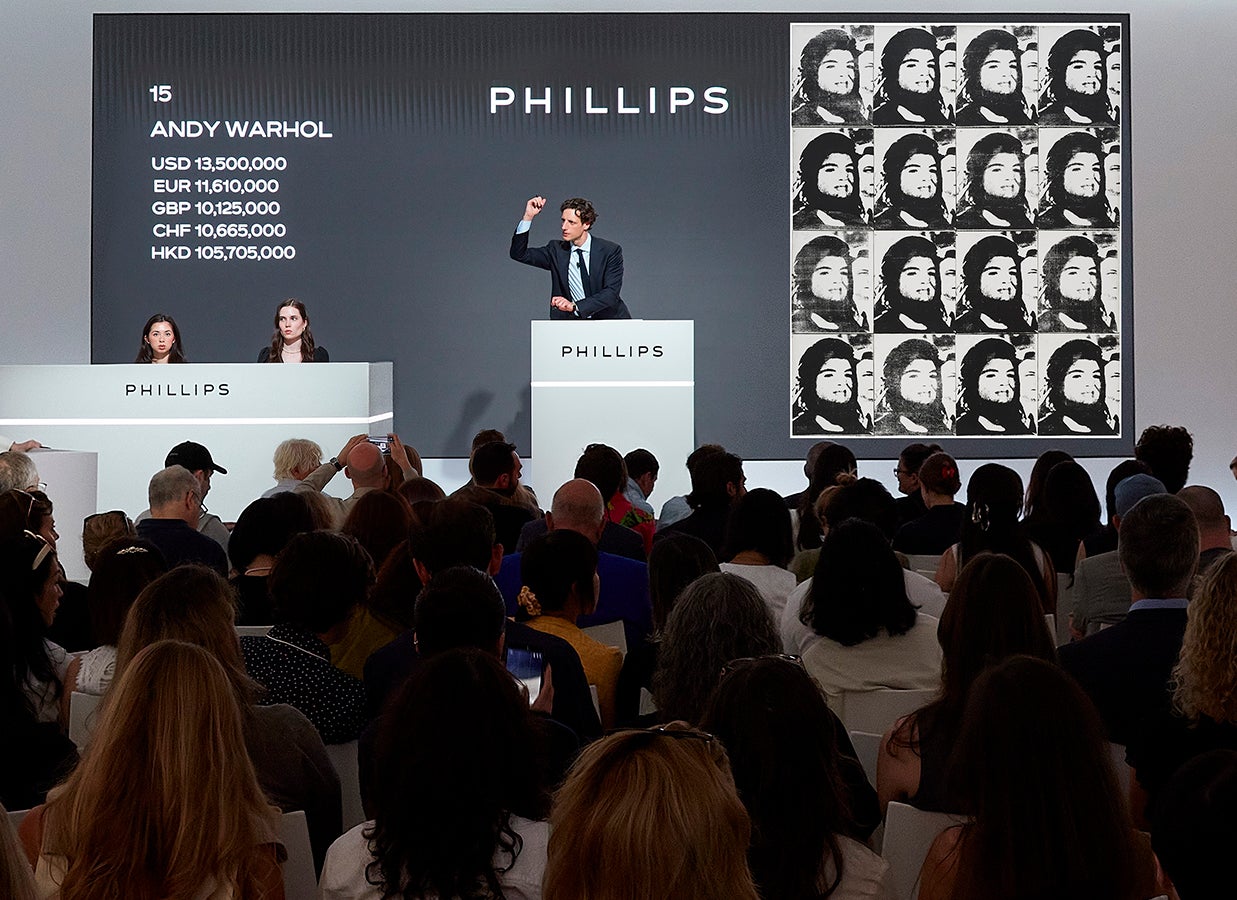 Henry Highley auctioneering Andy Warhol’s 1964 work 'Sixteen Jackies' at the Modern & Contemporary Art Evening Sale in New York on 19 May 2026.