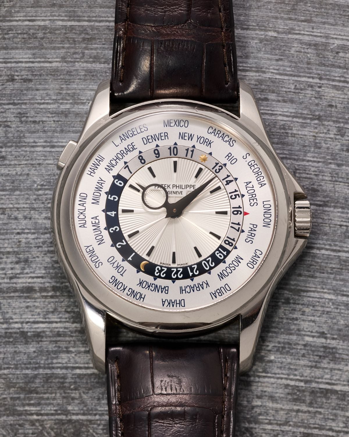 Lot 49: A circa 2010 Patek Philippe World Time Ref. 5130G-001 in 18k white gold, included in the Phillips New York Sessions, Fall 2026. Estimate: USD $18,000–36,000 