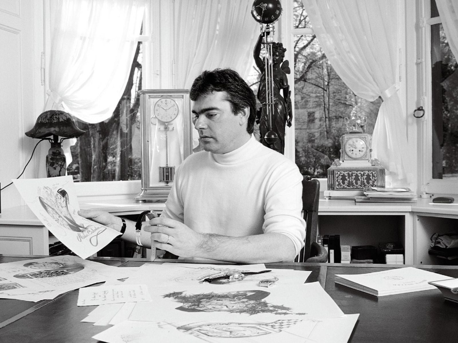 Franck Muller at his desk in the early 1990s, studying designs for the Cintrée Curvex. World Commerce Corporation