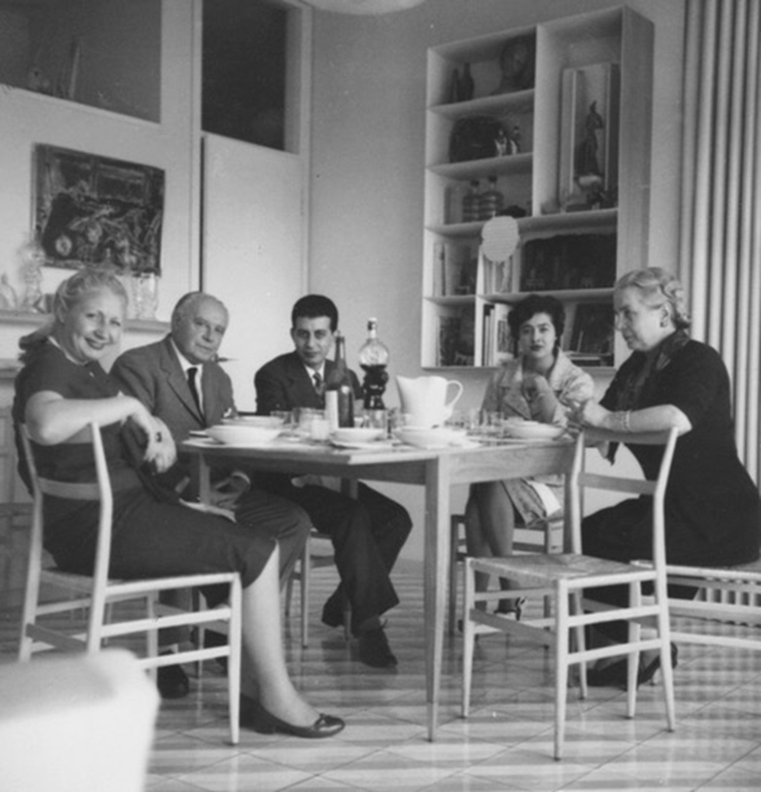Gio Ponti and the Nemazee family gathered around the present extendable dining table in Ponti's Via Dezza apartment, circa 1960. Image: © Gio Ponti Archives / archivio storico Gio Ponti