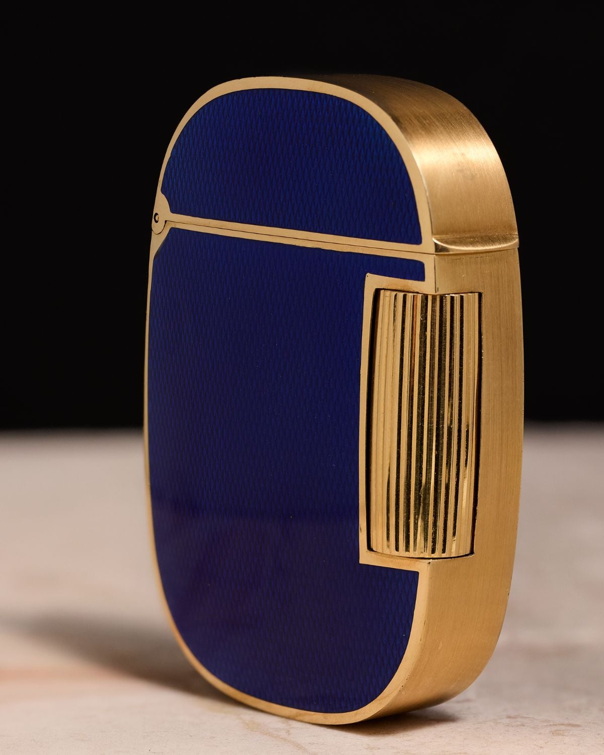 Lot 18: A circa 1978 Patek Philippe Golden Ellipse lighter Ref. 9507 in 18k yellow gold and blue enamel, included in the Phillips New York Sessions, Fall 2026. Estimate: USD $10,000–20,00