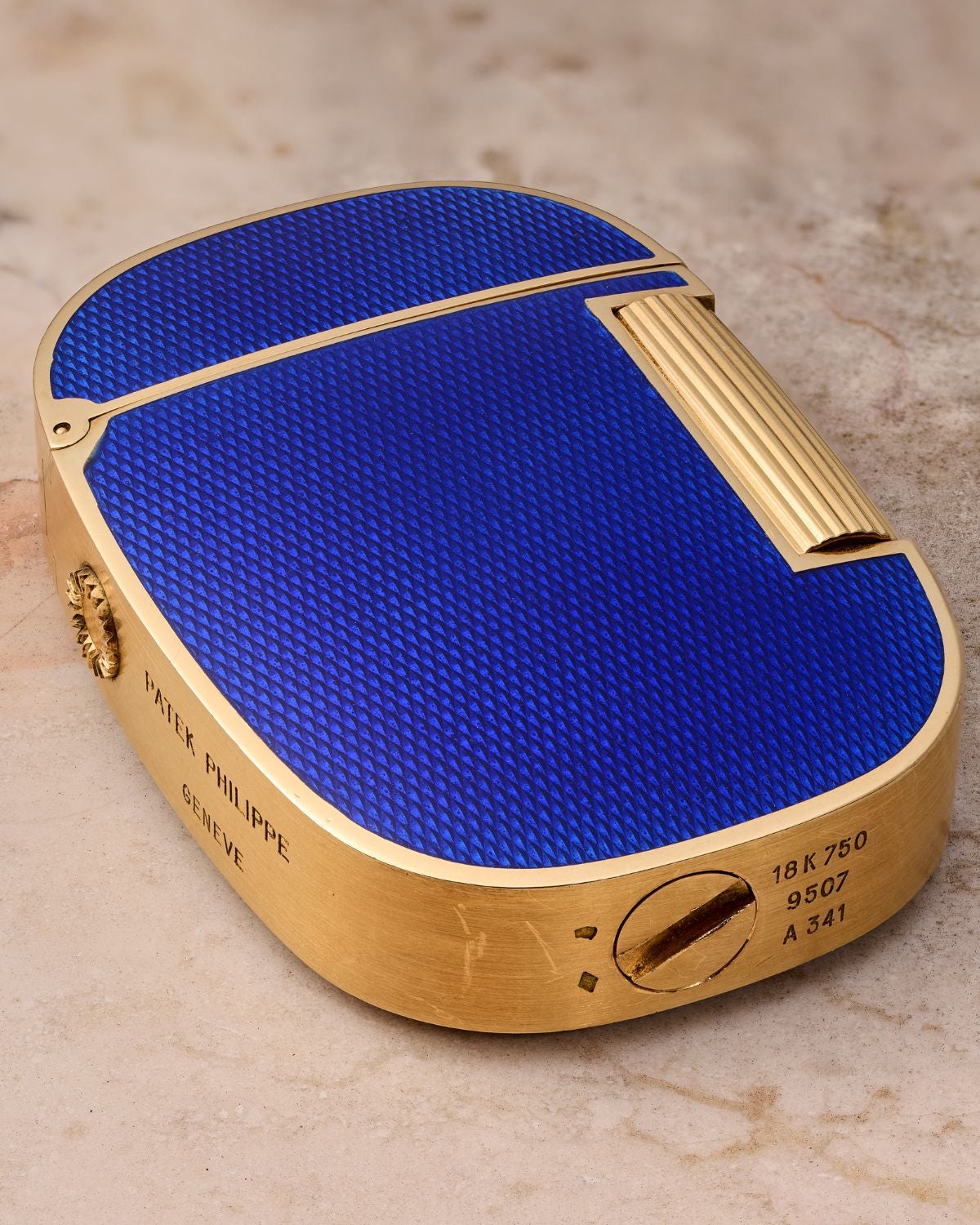 Lot 18: A circa 1978 Patek Philippe Golden Ellipse lighter Ref. 9507 in 18k yellow gold and blue enamel, included in the Phillips New York Sessions, Fall 2026. Estimate: USD $10,000–20,00